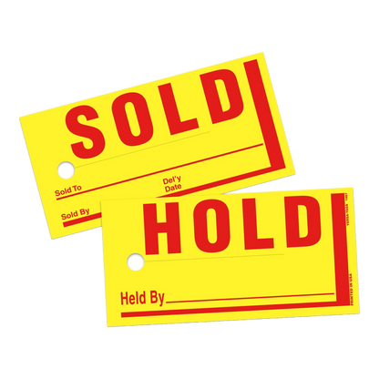 Yellow Sold and Hold tags with red lettering